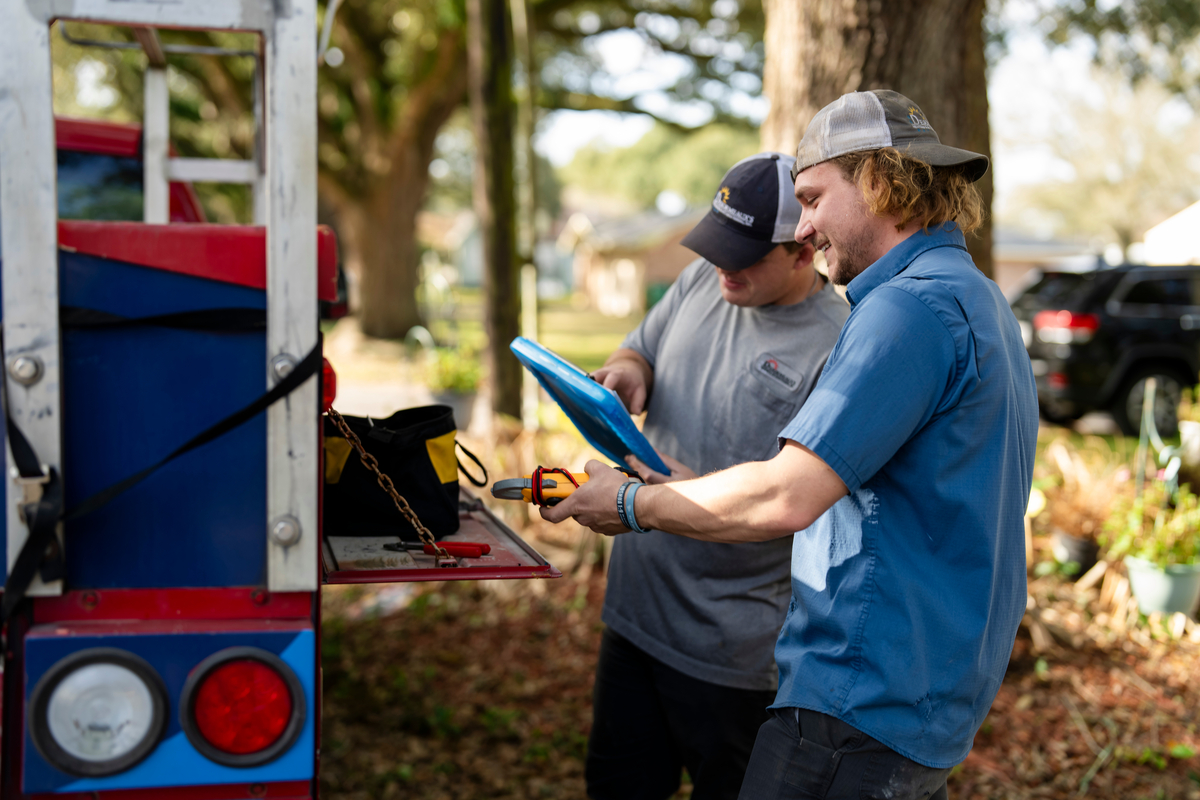 HVAC Technicians reviewing clipboard together